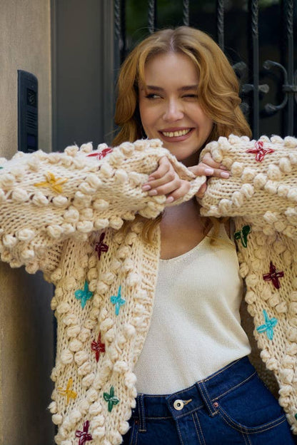 Knitted Cardigan Cross Pom Pom